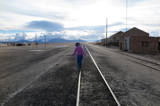 woman walking on rail tracks